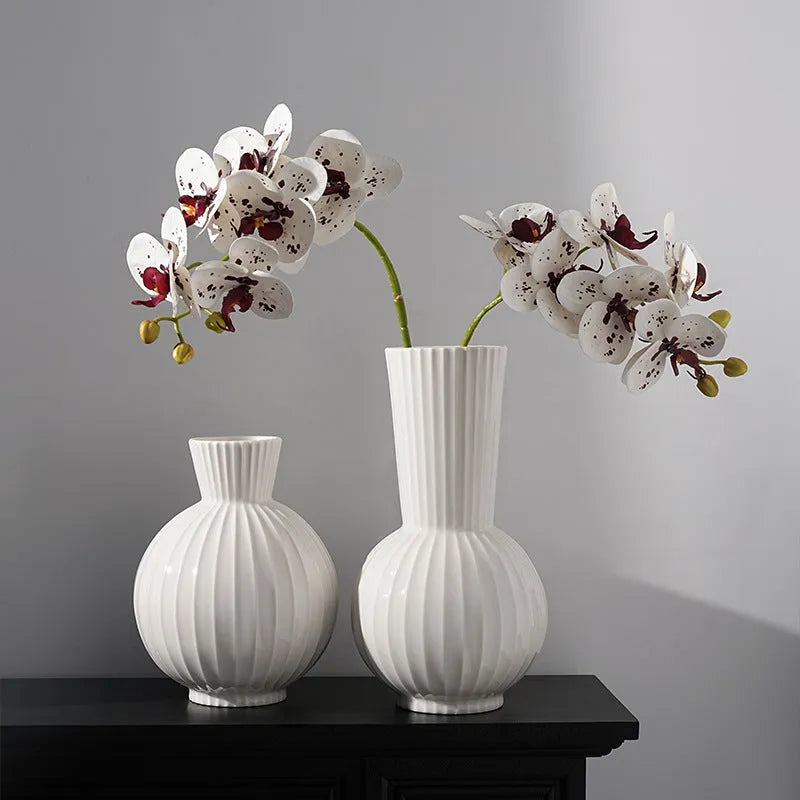 White ceramic ball vase with striped patterning in American country style on wooden table