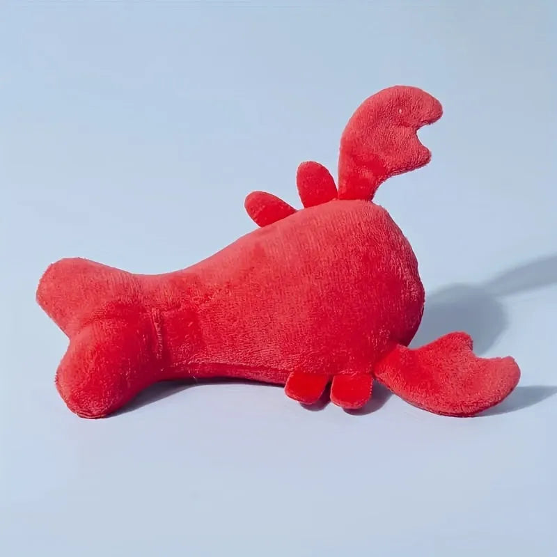 Red plush lobster-shaped squeaky dog toy for small and medium breeds.