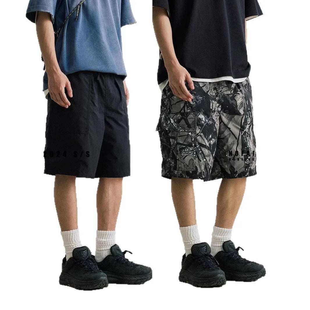 Straight-leg denim shorts in black and army green colours showing loose casual fit and mid waist design