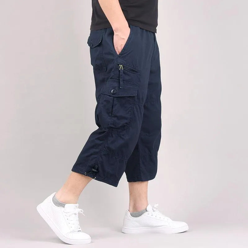 Men's loose fit cotton cropped pants in army green colour, shown on a hanger.