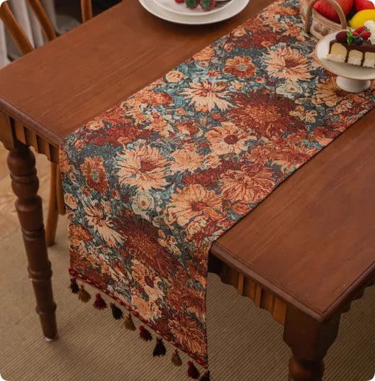 Country European retro style table flag with long handwoven tassels draped over a wooden sideboard.