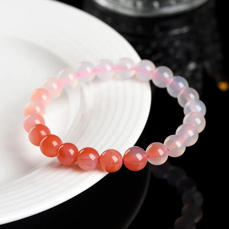 Natural gradient Yanyuan agate beaded bracelet with geometric polished beads on a wrist.