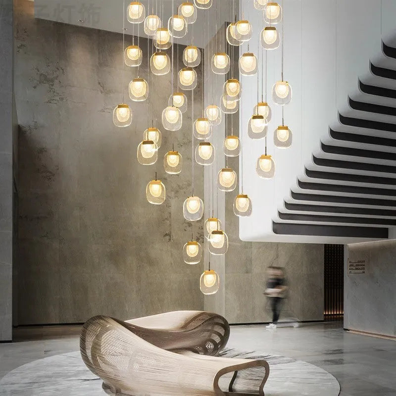 Postmodern crystal chandelier with six gold heads, stainless steel chassis, and adjustable cable on a ceiling