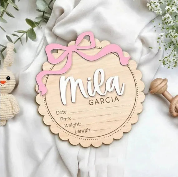 A square wooden ornament personalised with a baby's name for nursery decoration or photo prop.