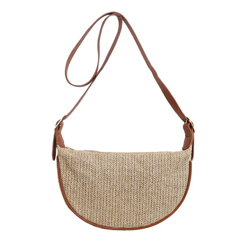 Straw woven crossbody bag showing woven texture and interior phone compartment