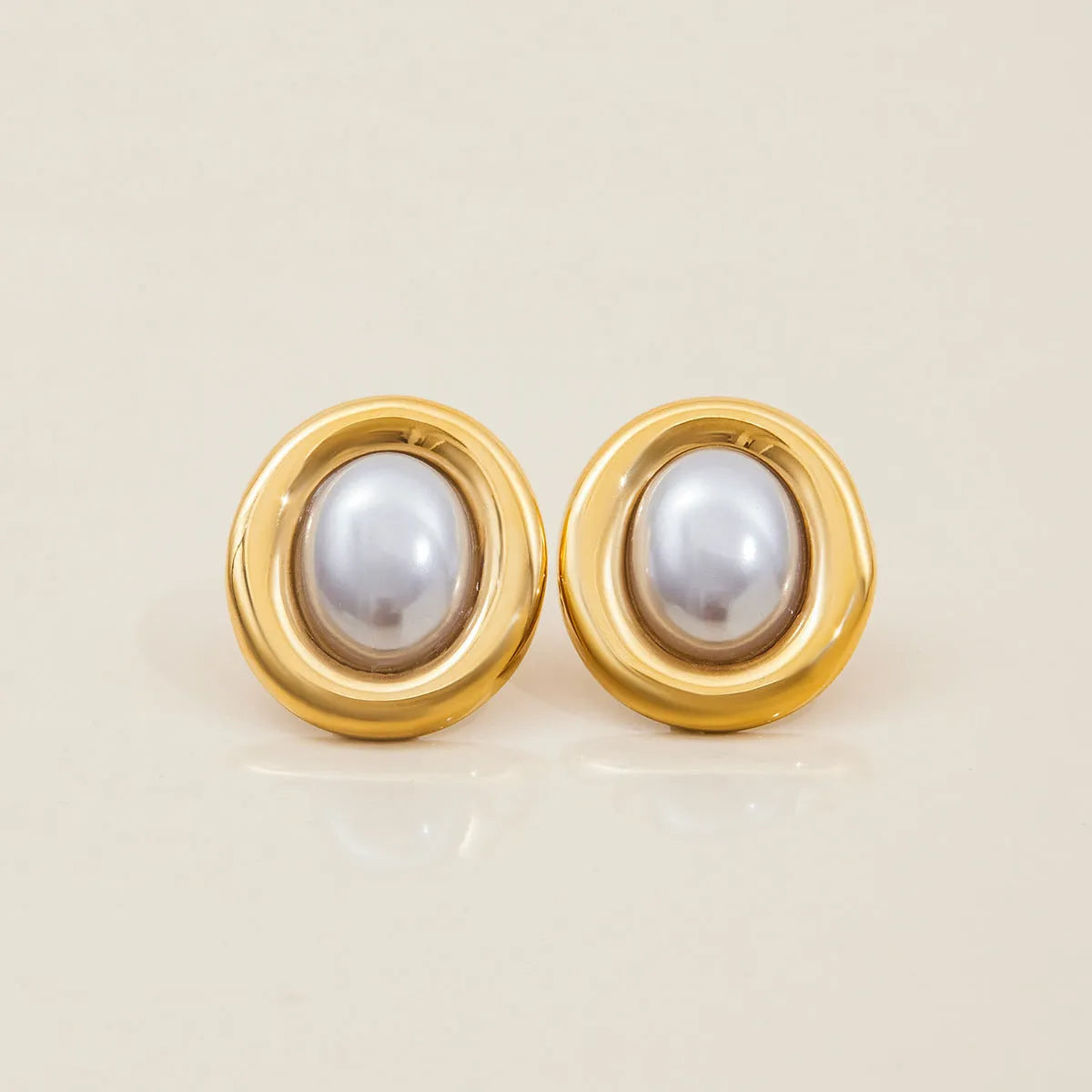 A pair of stainless steel vintage pearl stud earrings for women with an electroplated finish.