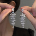 Silver pagoda coloured copper Christmas tree drop earrings with sparkling zircon details and stud fastening.