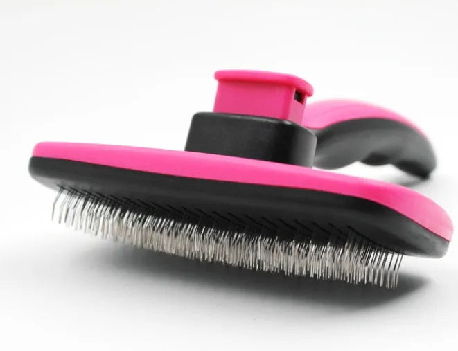 Automatic dehairing comb with stainless steel teeth and rose red handle, for dog and cat grooming, on a white background