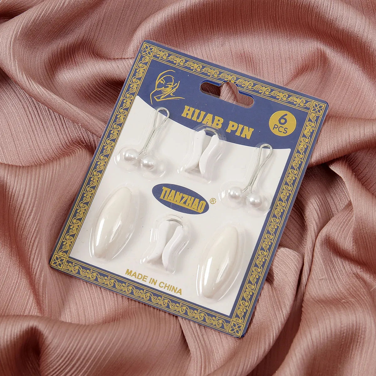 Plastic scarf clip with oval meander pattern and resin drip finish in five colours including black, gray, white, brown, and pink.
