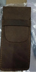 Brown leather pencil case with zip opening on a plain background