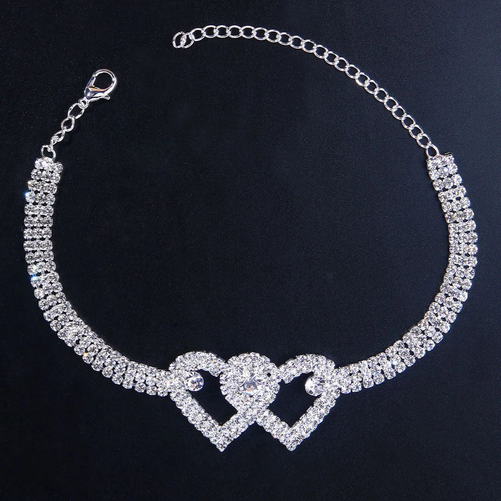 Set of two alloy double heart anklets with electroplated finish, unisex style, displayed together