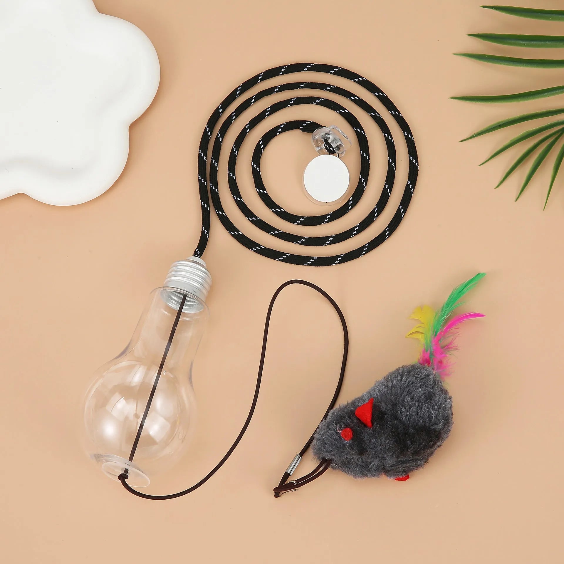 Interactive cat toy hanging from door frame with dangling mouse and chicken toys on elastic rope
