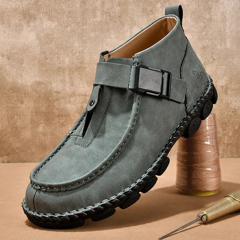 Men's black casual slip-on shoes with handmade stitching on the synthetic leather upper and a flat sole.