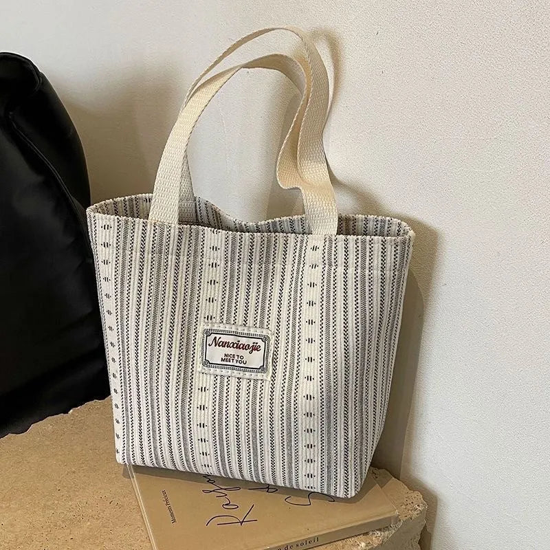 Japanese-style corduroy shoulder bag in dark brown, showing the textured fabric and adjustable strap.