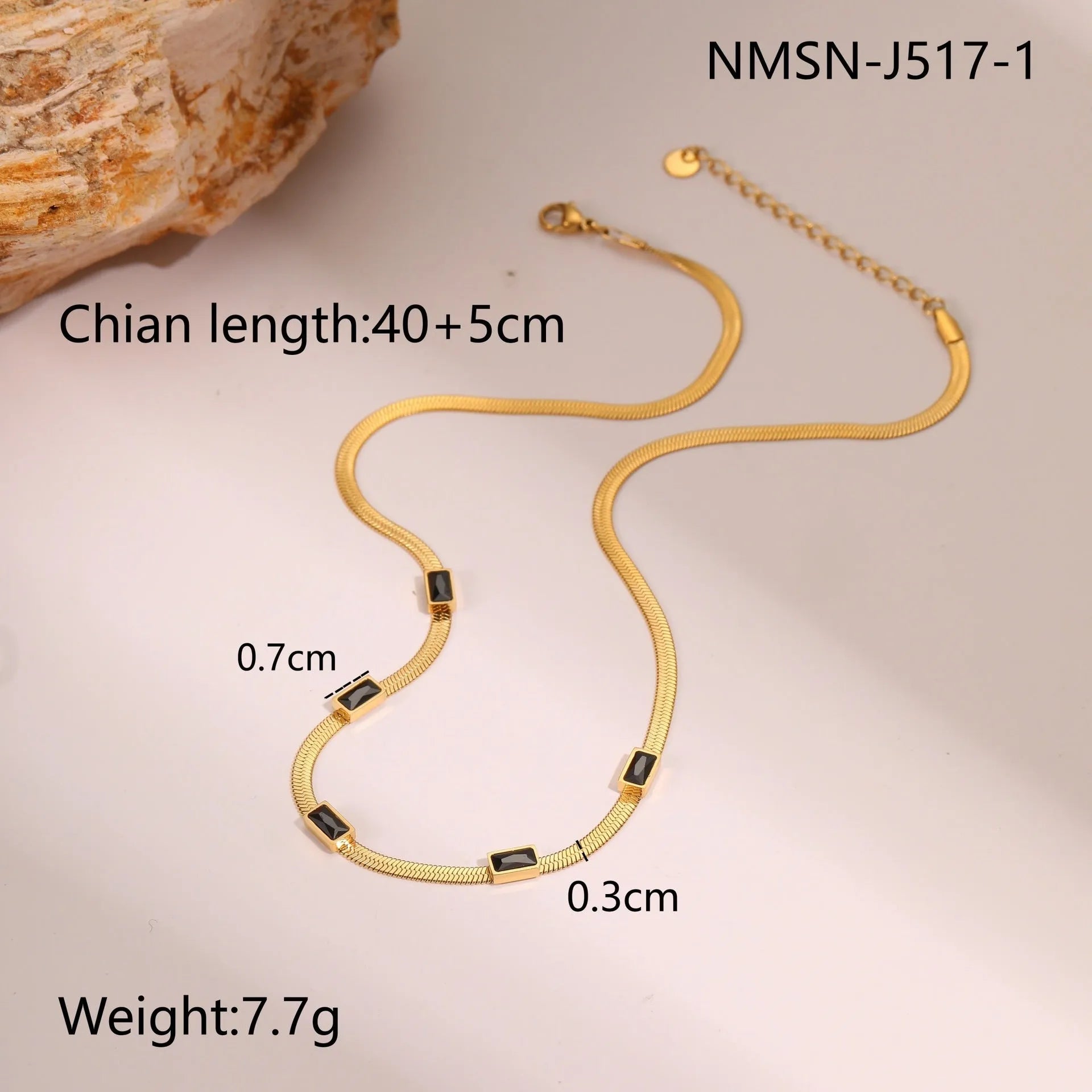 Geometric square zircon pendant on a flat stainless steel snake chain necklace in a gold colour finish.