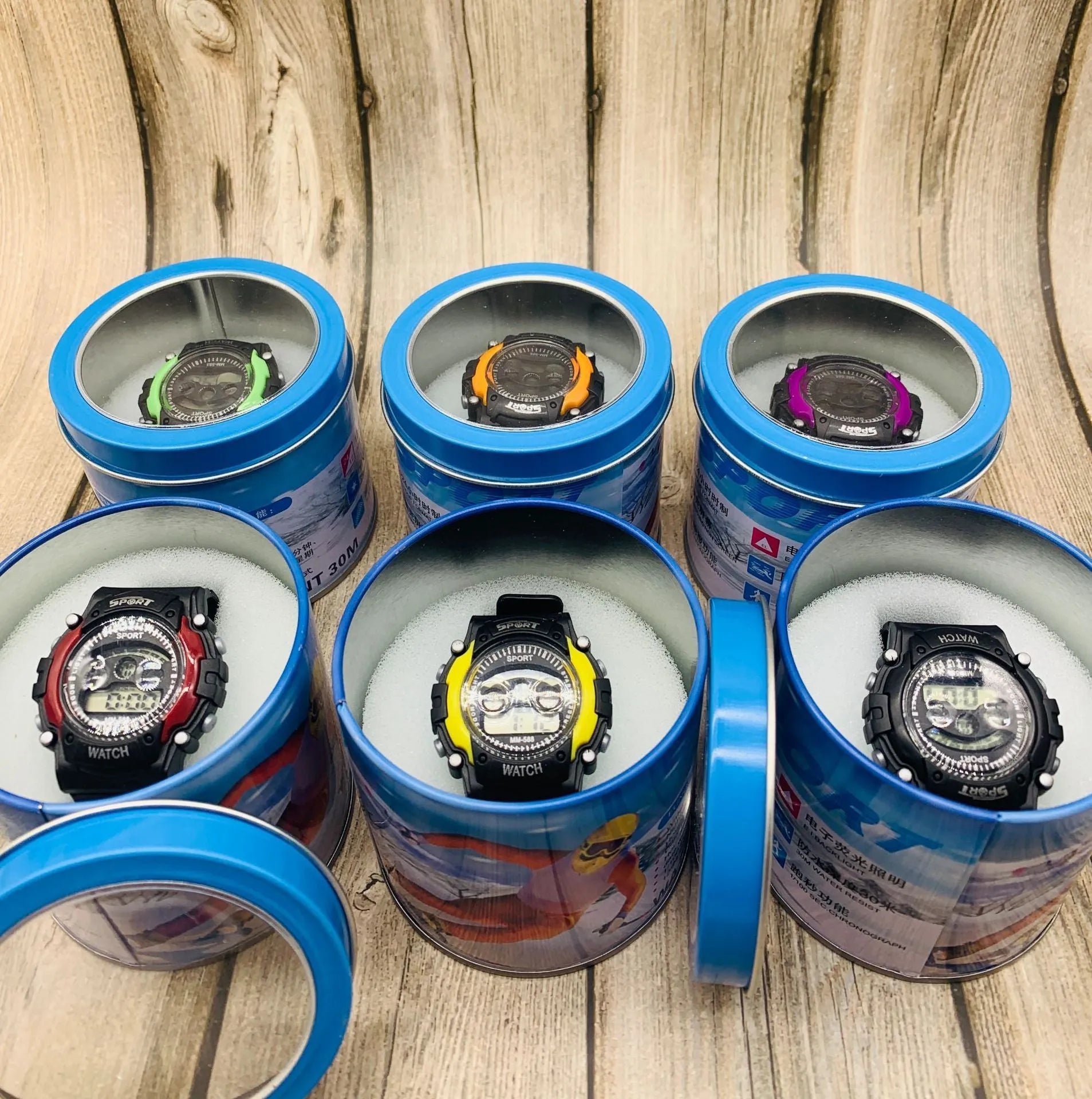 Digital sports watch for children with silicone strap, plastic case and multiple functions including alarm and lighting