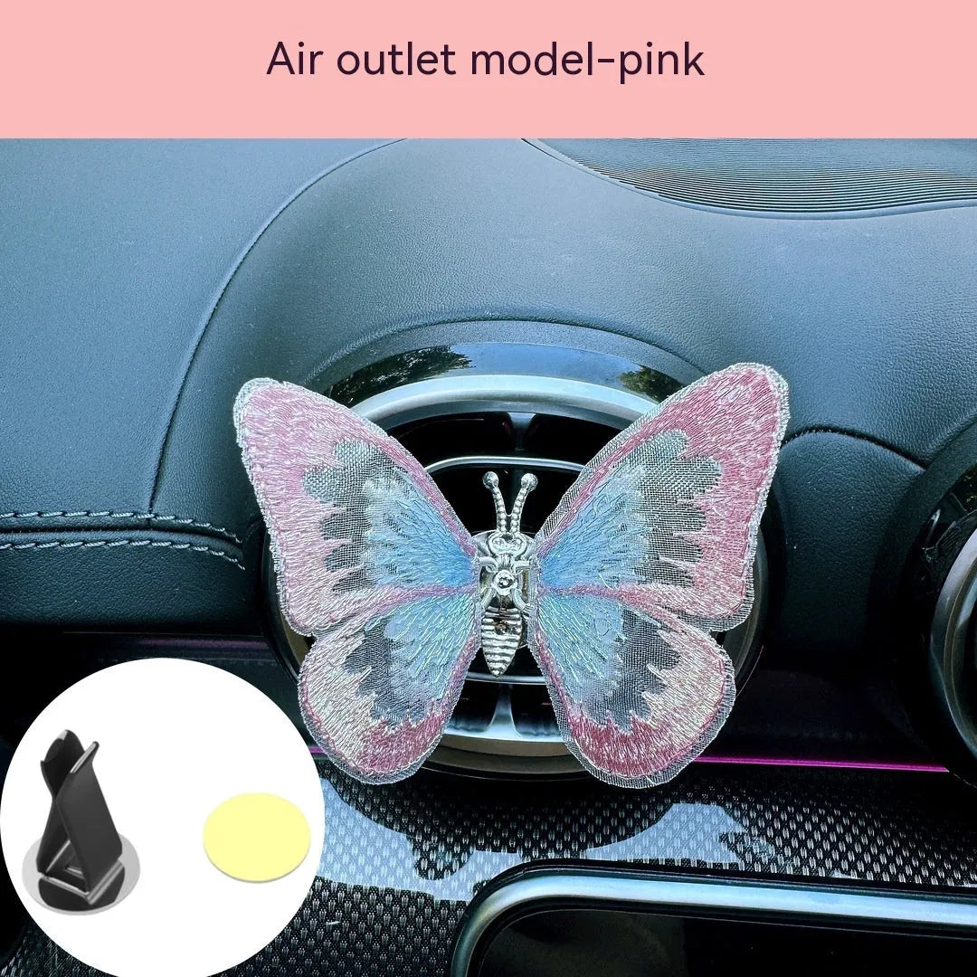 Moving embroidery butterfly decoration on car centre console air vent in pink fabric