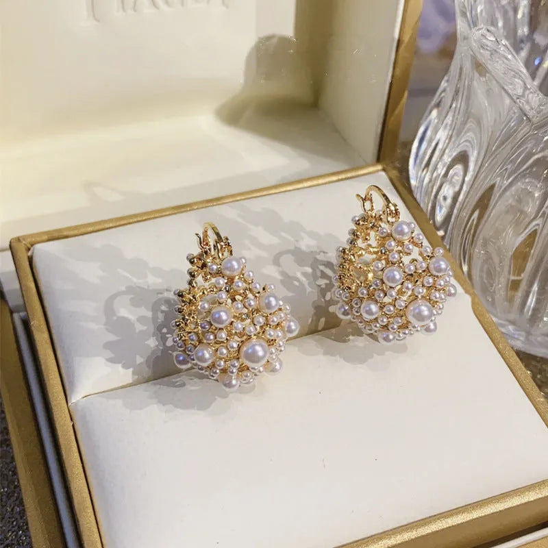 Gold floral basket-shaped women's earrings made from small rice beads with pearl inlay on copper.