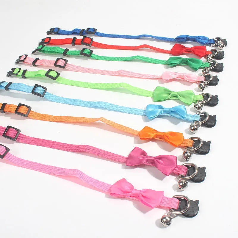 Adjustable striped nylon cat collar with a small bell, shown in multiple colour options on a white background.