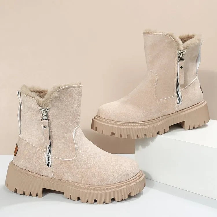 Women's black snow boots with foldable plush tube, suede upper, and rubber sole on winter pavement