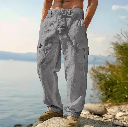 Men's loose cotton wide-leg casual trousers in light army green colour on a hanger.