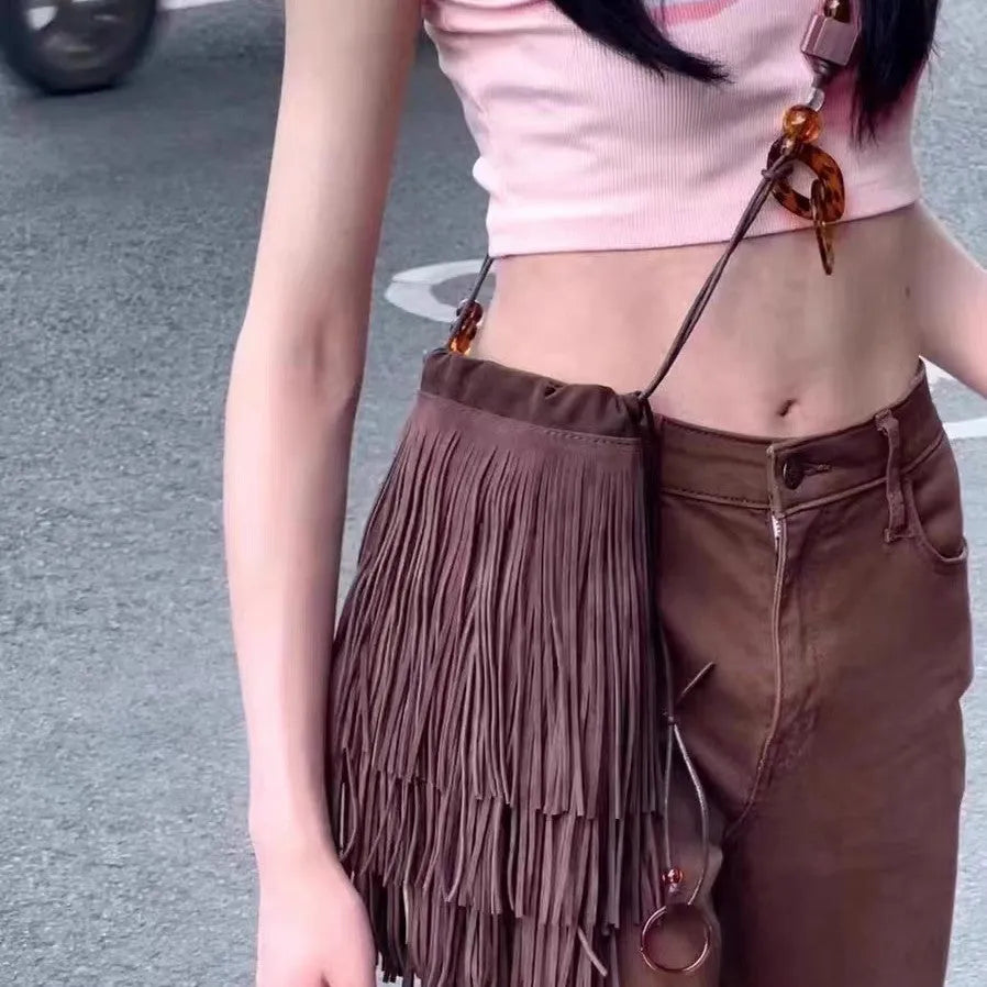Maroon drawstring beaded tassel crossbody bag with soft plush exterior and single shoulder strap