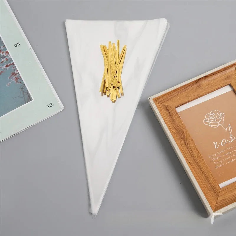 Transparent triangular plastic bag with a red wire tie closure.