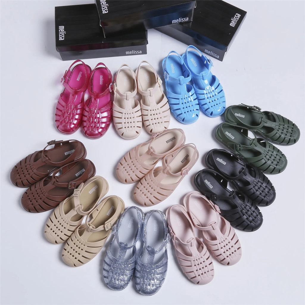 Black Roman-style sandals with buckle fastening and hollow-out design on low-top PVC upper