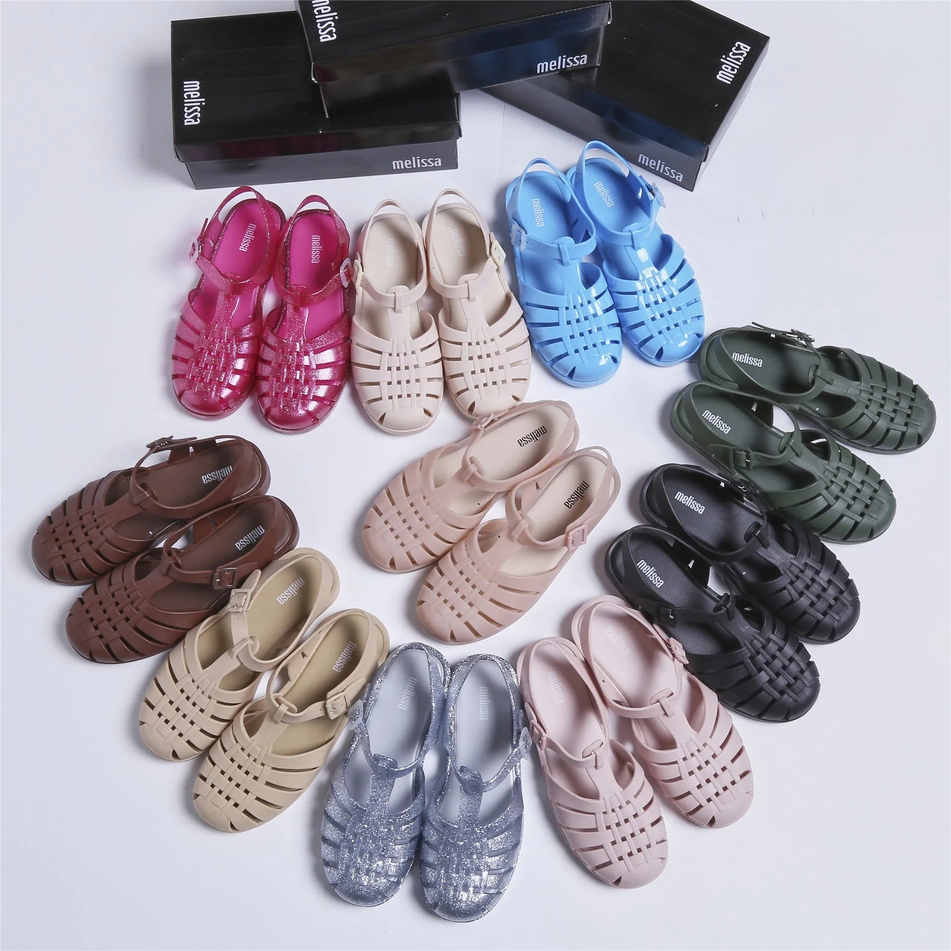 Black Roman-style sandals with buckle fastening and hollow-out design on low-top PVC upper
