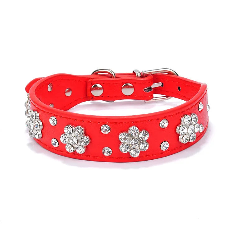 Decorative black PU leather dog collar with studded rhinestone flower pattern and silver metal D-ring.