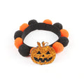 Halloween pet fur ball collar accessory for small dogs and cats in pumpkin, skull, and witch designs.