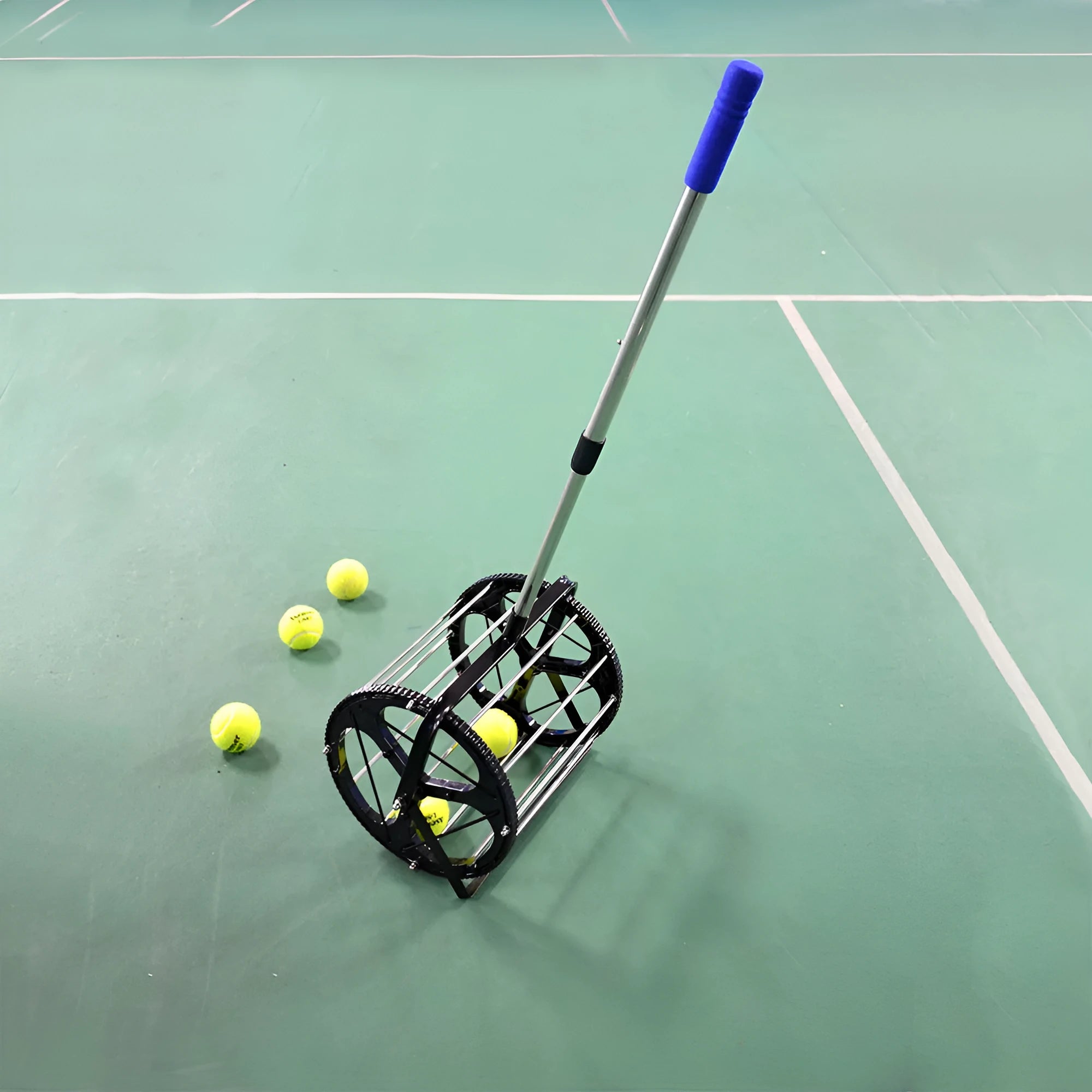 Black tennis ball picker basket made of nylon and metal on a court surface