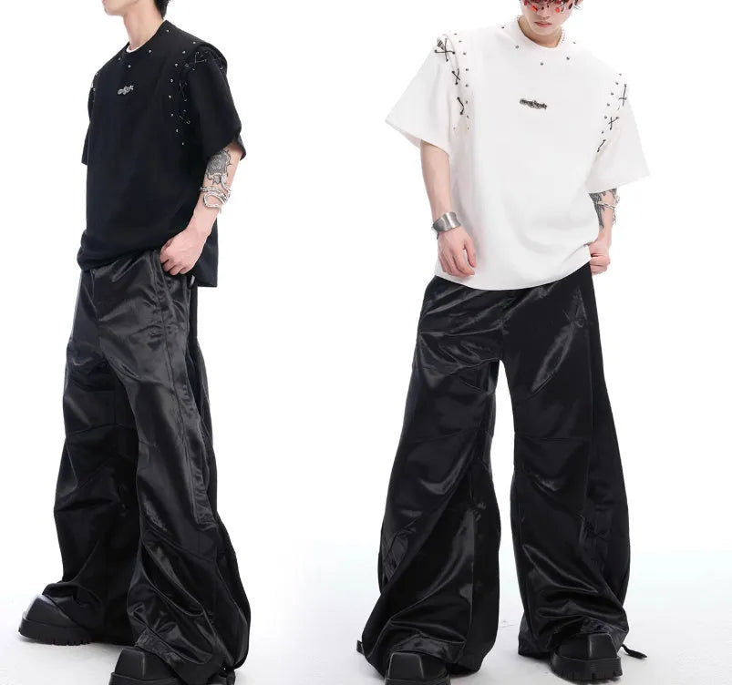 Short sleeve black top with a white lace-up cutout detail on the front, deconstruction style.