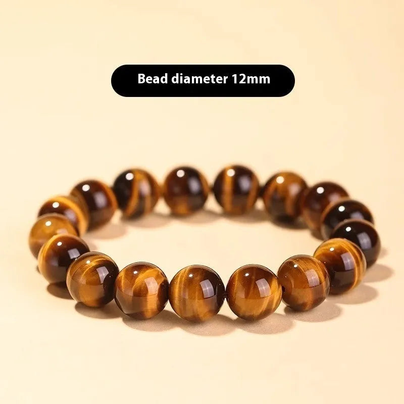 Single Tigereye Dzi bead Buddha rosary bracelet on wrist, showing simple ethnic design.