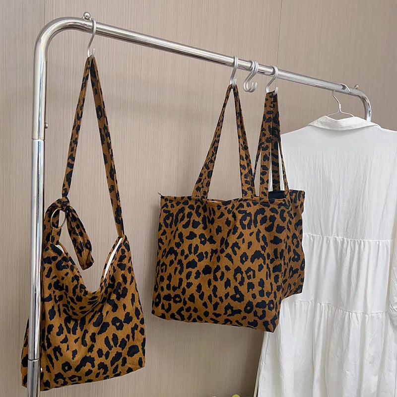 Length adjustable canvas shoulder bag in vintage leopard print with zipper closure