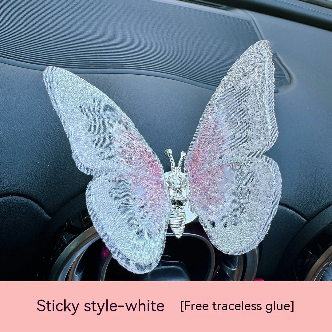 Moving embroidery butterfly decoration on car centre console air vent in pink fabric