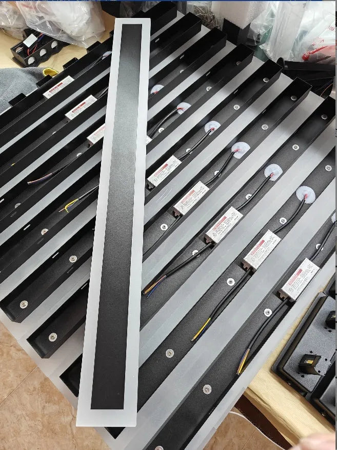 150cm long straight outdoor LED wall lamp with black wrought iron shell and warm white light.