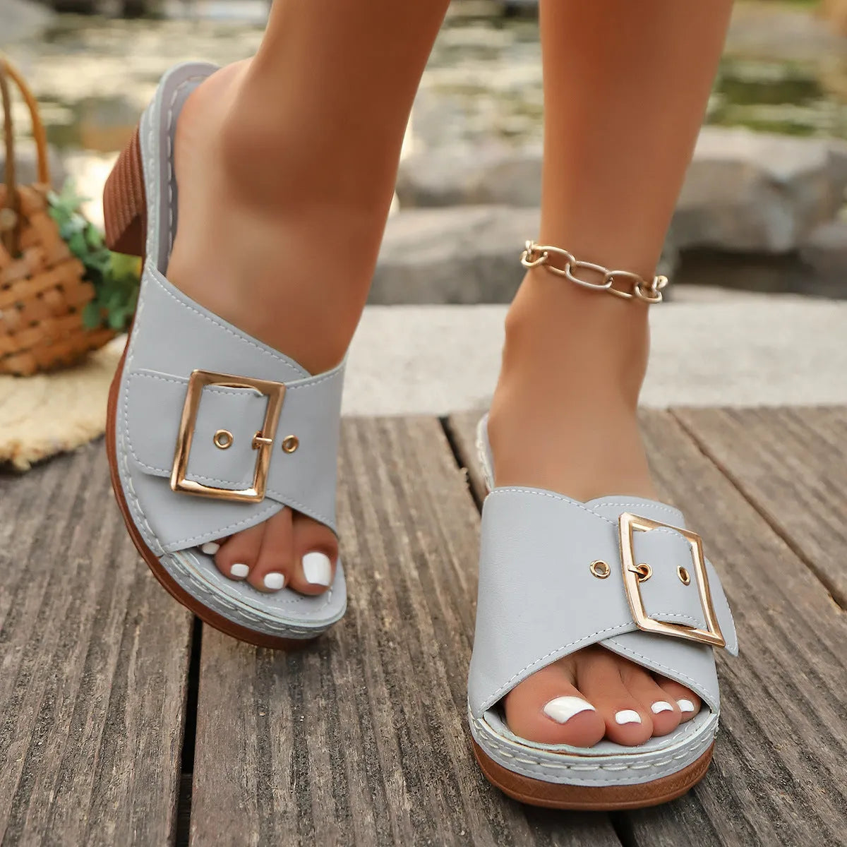 Women's black retro slippers with a chunky block heel and silver metal buckle closure