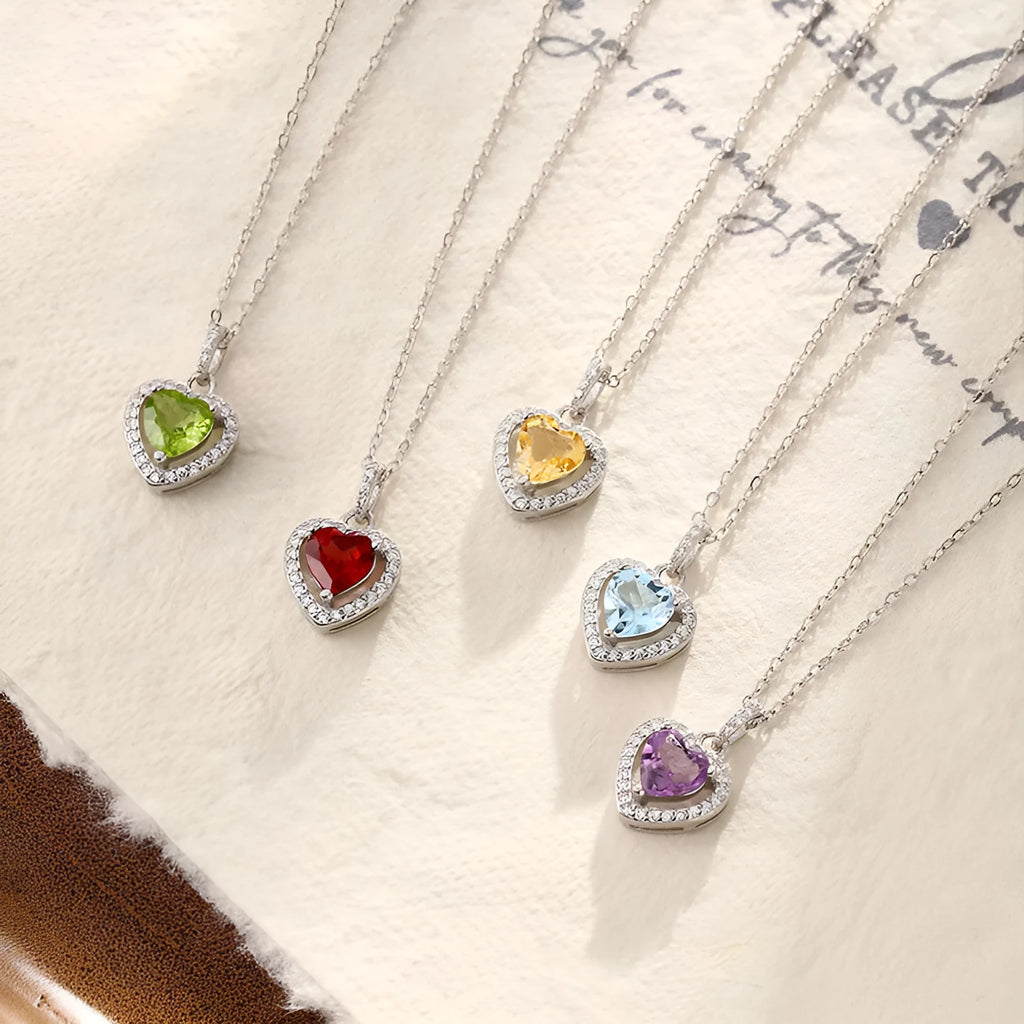 Sterling silver heart pendant necklace with a natural coloured gemstone on an adjustable cross chain.