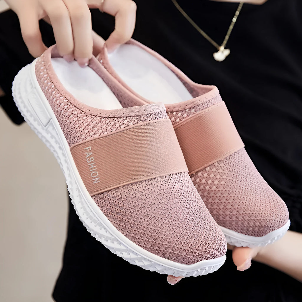Women's black mesh casual flat shoe with round toe and hollow-out design on a neutral background.