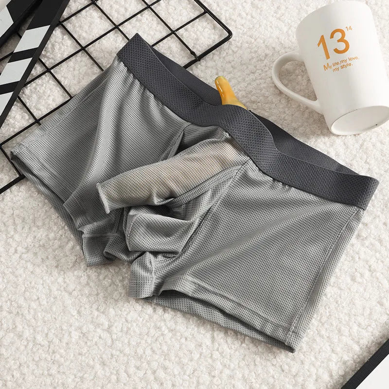 Men's solid colour ice silk boxer briefs with a low waist and mesh knit fabric.