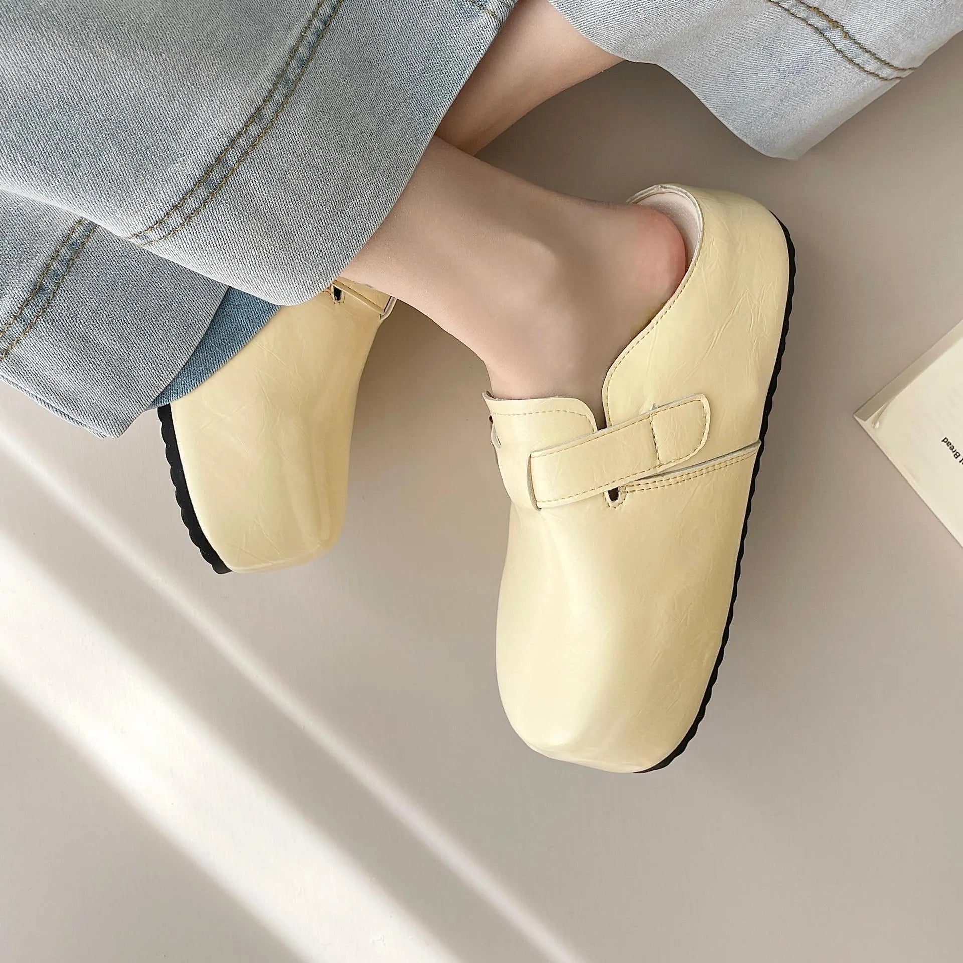 Women's flat buckle casual sneakers in yellow, creamy-white, silver, and black colours with round toe design