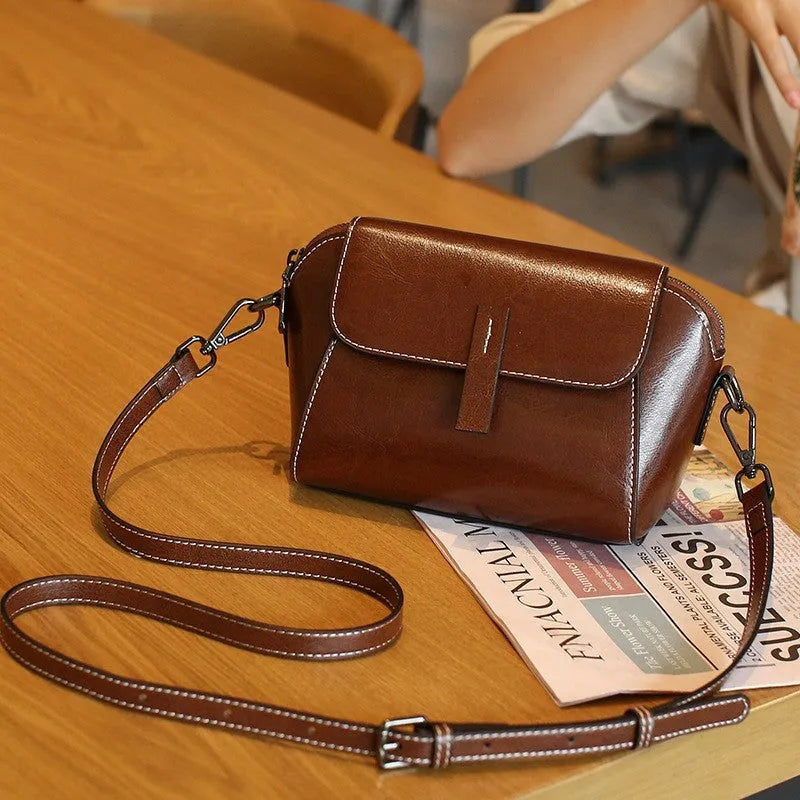 Women's brown oil wax leather messenger bag with cross-body strap and multiple internal compartments
