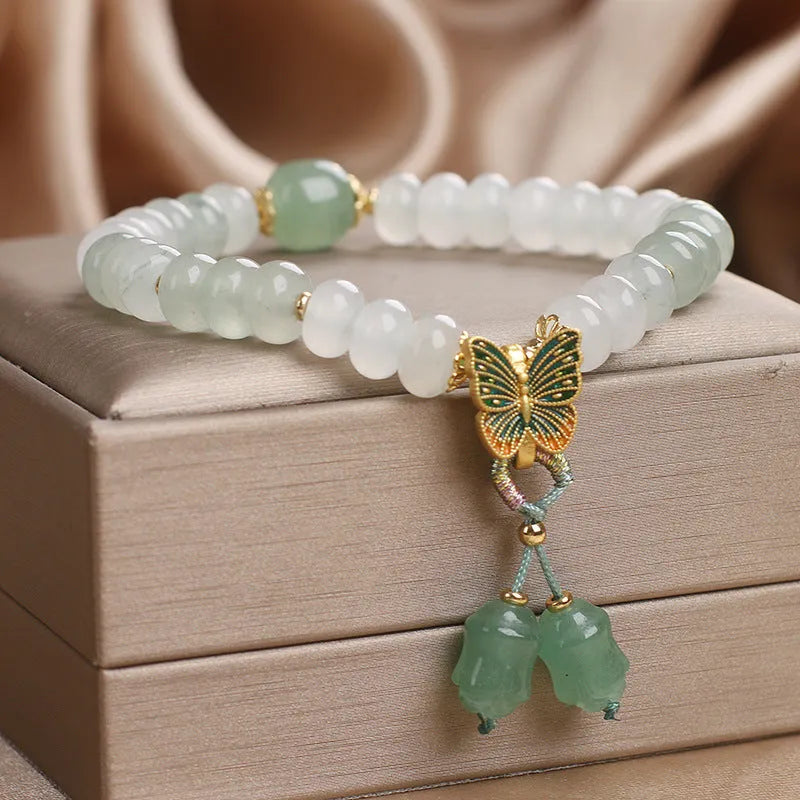 Green crystal women's bracelet with abacus beads, butterfly tassel, rhinestones and pearls