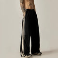 Man wearing black high-waisted straight-leg casual climbing trousers.