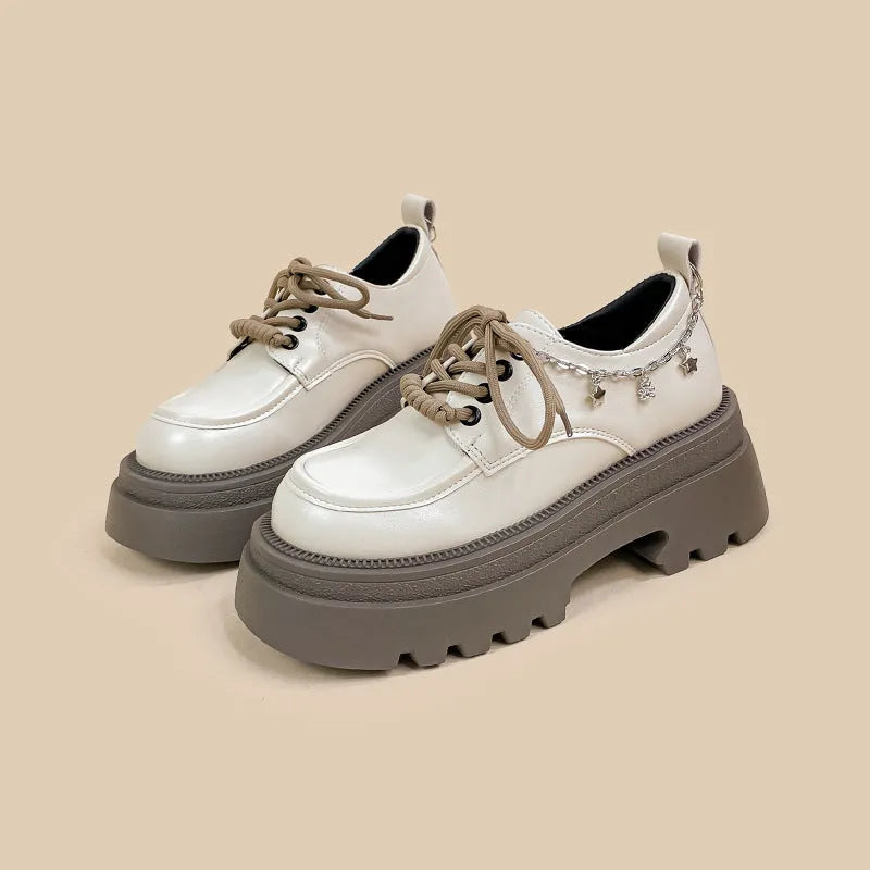 White women's platform Mary Jane shoes with a round toe, chunky high heel, and front lace-up detail.