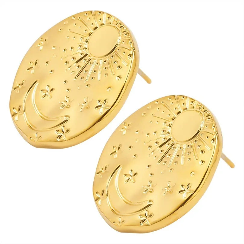 A pair of stainless steel geometric shell stud earrings in a gold electroplated finish on a white background.