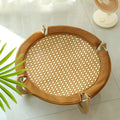 Brown square woven rattan raised hammock bed for cats and dogs on a wooden floor.