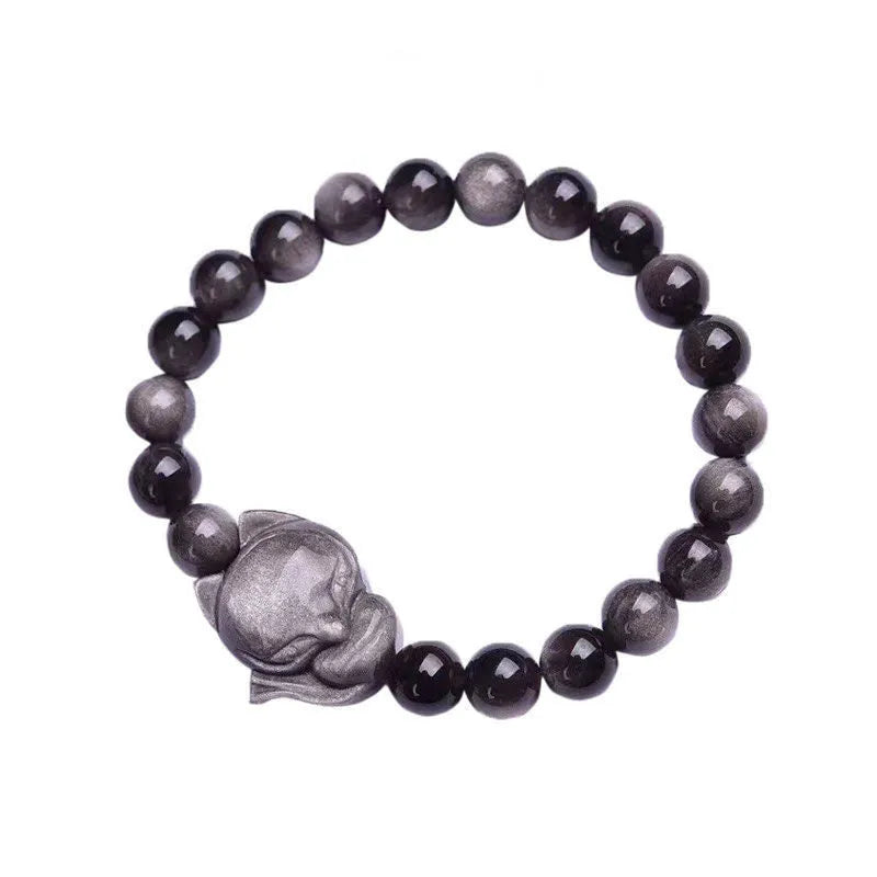 Close-up of a women's adjustable bracelet with a dark obsidian fox bead and sliding knot.