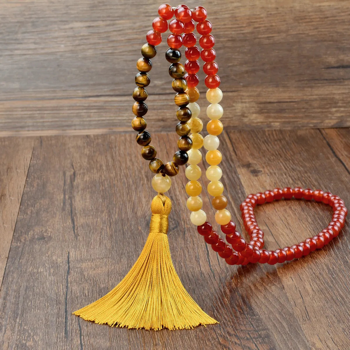 Long bohemian necklace with 108 natural stone beads, a geometric pendant, and a coloured tassel on a ball bead chain.